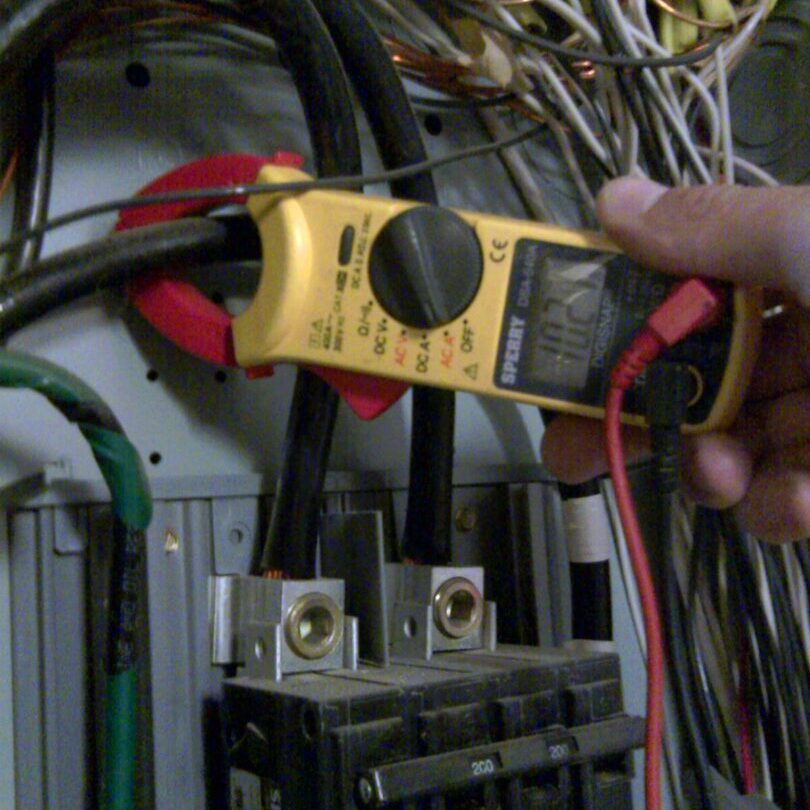 Yellow energy testing equipment connected to a distribution board
